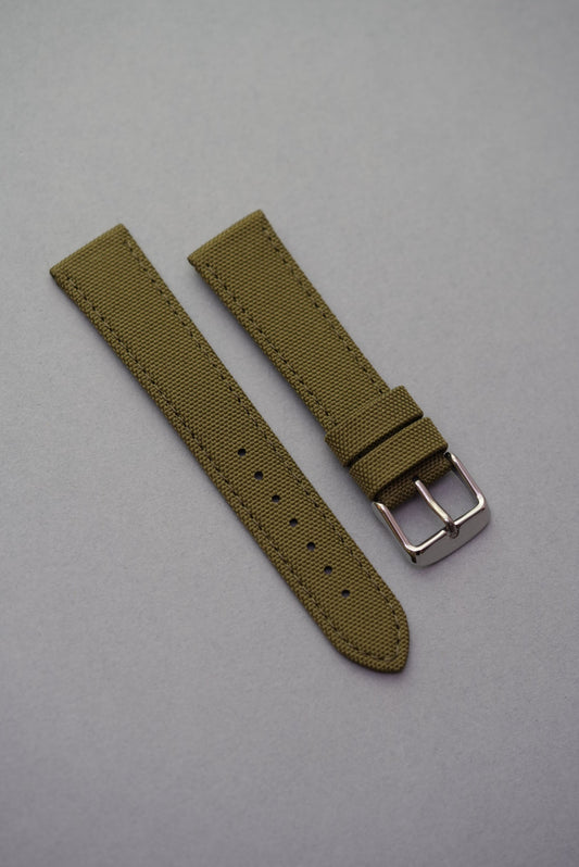 Military-style olive green canvas strap with textured weave and polished buckle, compatible with MoonSwatch.