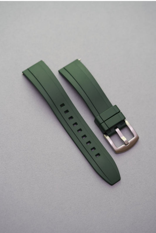 A green FKM rubber watch strap for OMEGA Seamaster Diver 300M with a silver buckle on a grey background.