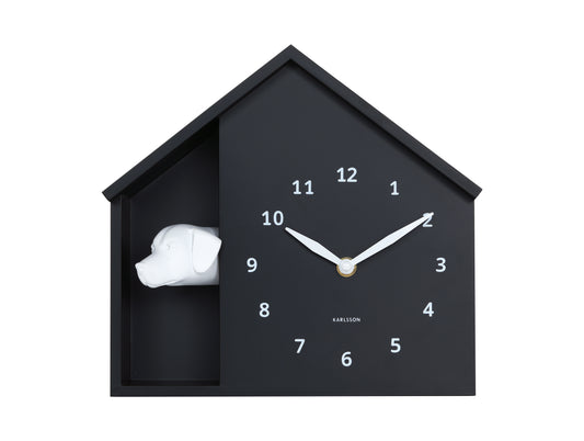 Black house-shaped clock with white rabbit inside on a white background