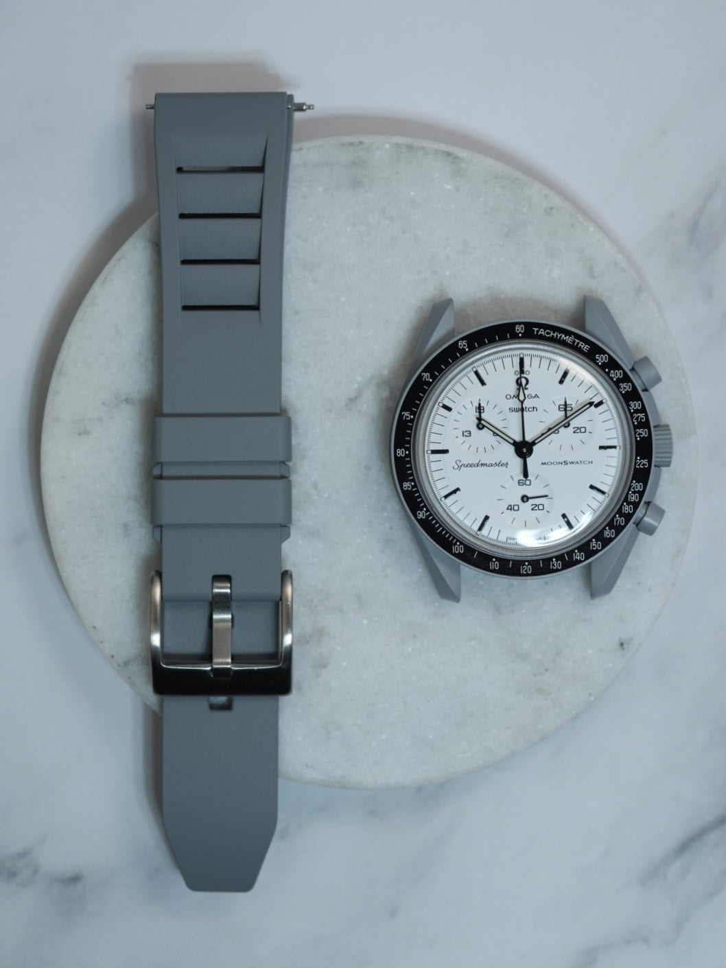 Grey FKM rubber watch strap with a vented design and stainless steel buckle, offering durability and a modern aesthetic. Compatible with MoonSwatch and traditional watches