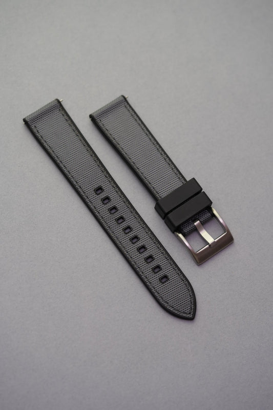 sailcloth-style rubber strap with textured surface and black buckle, designed to fit MoonSwatch cases with durability and comfort.