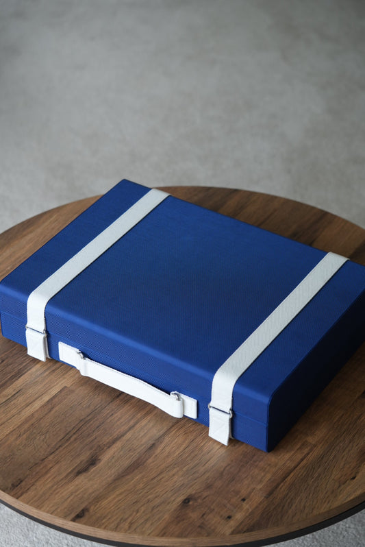 Blue box with white straps on a wooden surface
