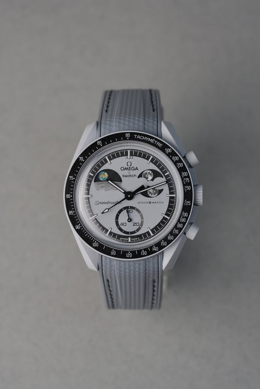 Silver watch with detailed face on a gray background