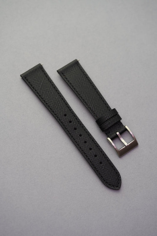 A black Italian Saffiano leather strap for a watch, displayed on a grey background.