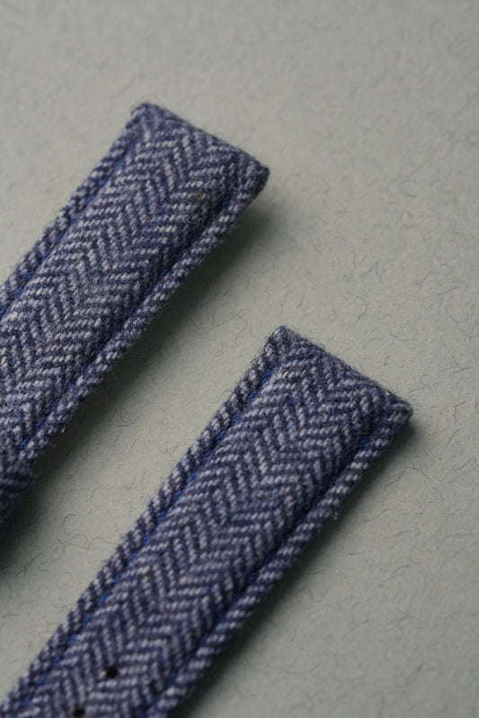 Two herringbone-patterned ribbons on a gray background