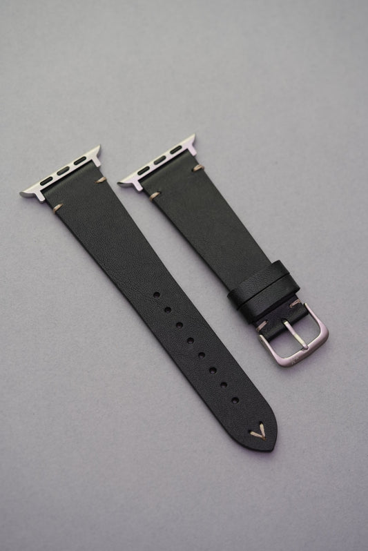 Close-up of black calfskin leather replacement strap with stainless steel buckle and contrast stitch.