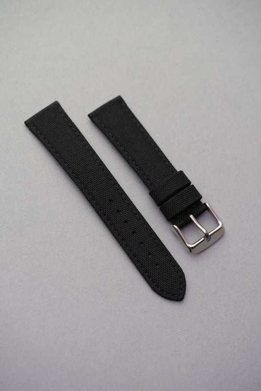 Classic black fabric strap with canvas texture and polished buckle, tough and lightweight for MoonSwatch compatibility.