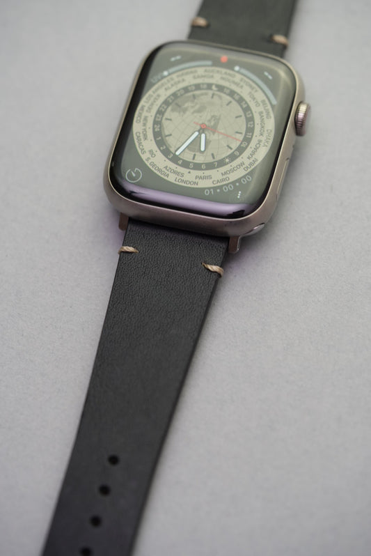 Detail shot of black leather strap for Apple Watch with hand-stitched lugs, ideal for luxury upgrade.