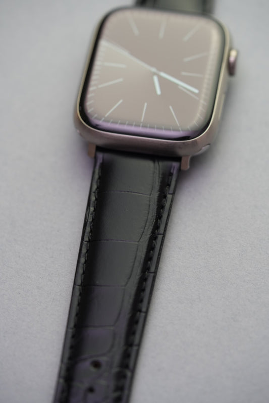 Louisiana alligator leather strap in black fitted to Apple Watch, close-up on wrist