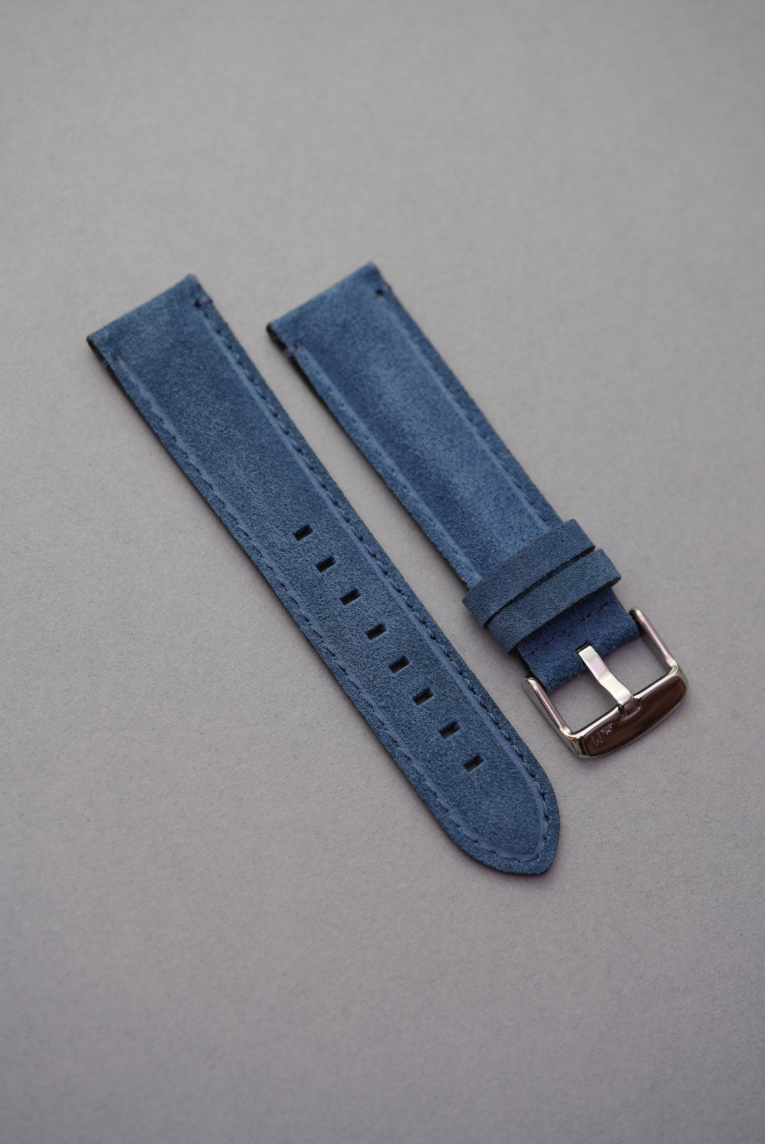 Blue suede leather strap laid flat with silver-tone buckle – standard watch strap replacement