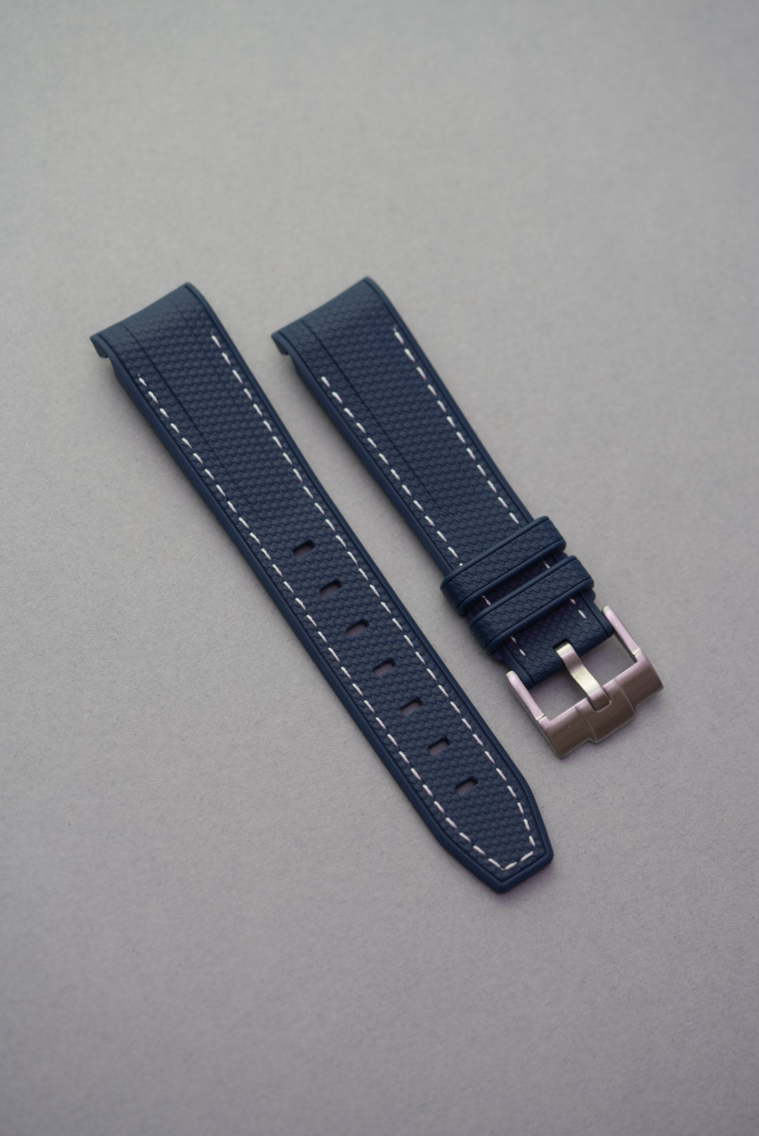 Textured navy rubber strap with white contrast stitching and curved ends, compatible with Omega x Swatch MoonSwatch.