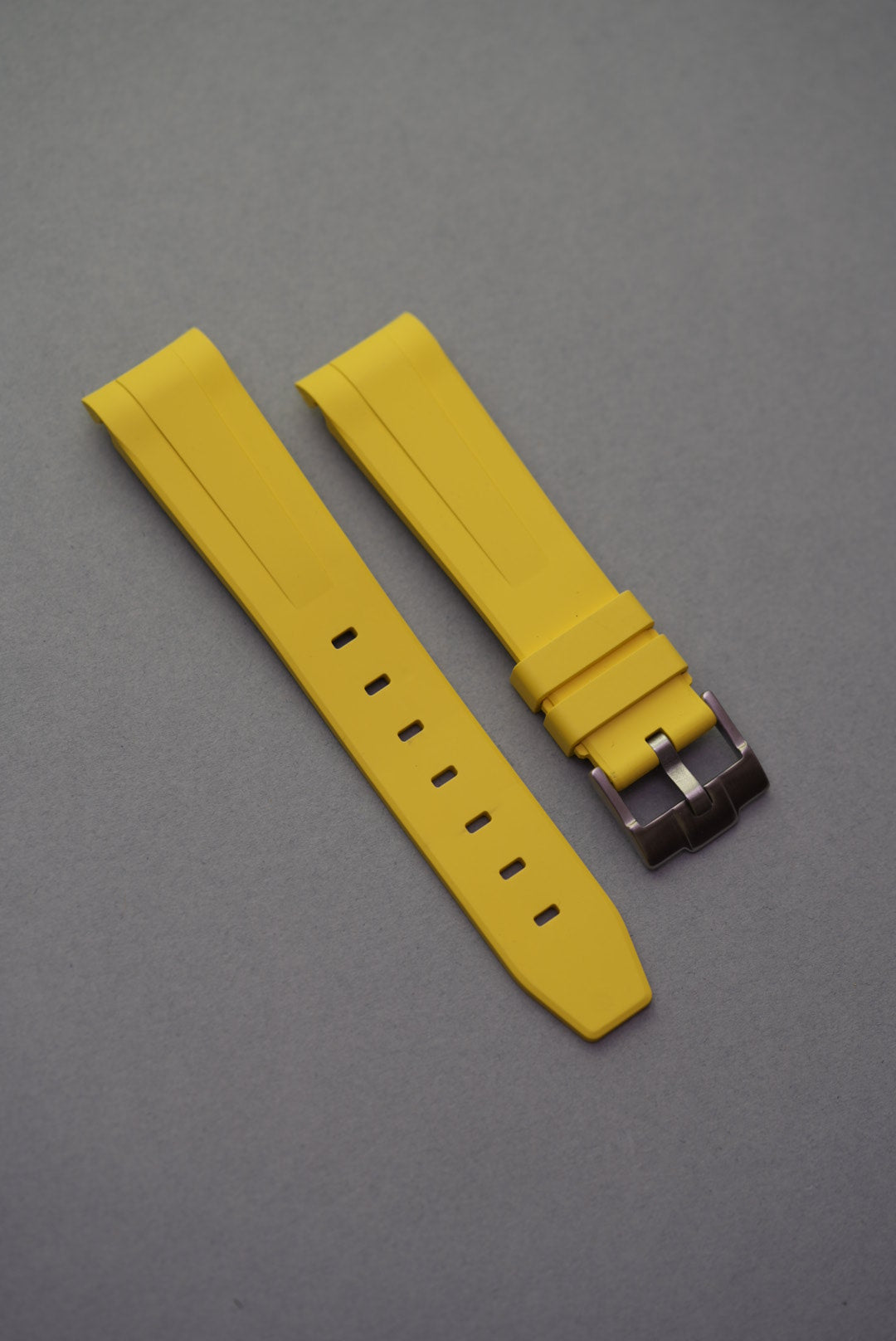 Bright yellow FKM rubber strap for MoonSwatch with a clean, smooth surface and curved lugs for case integration.
