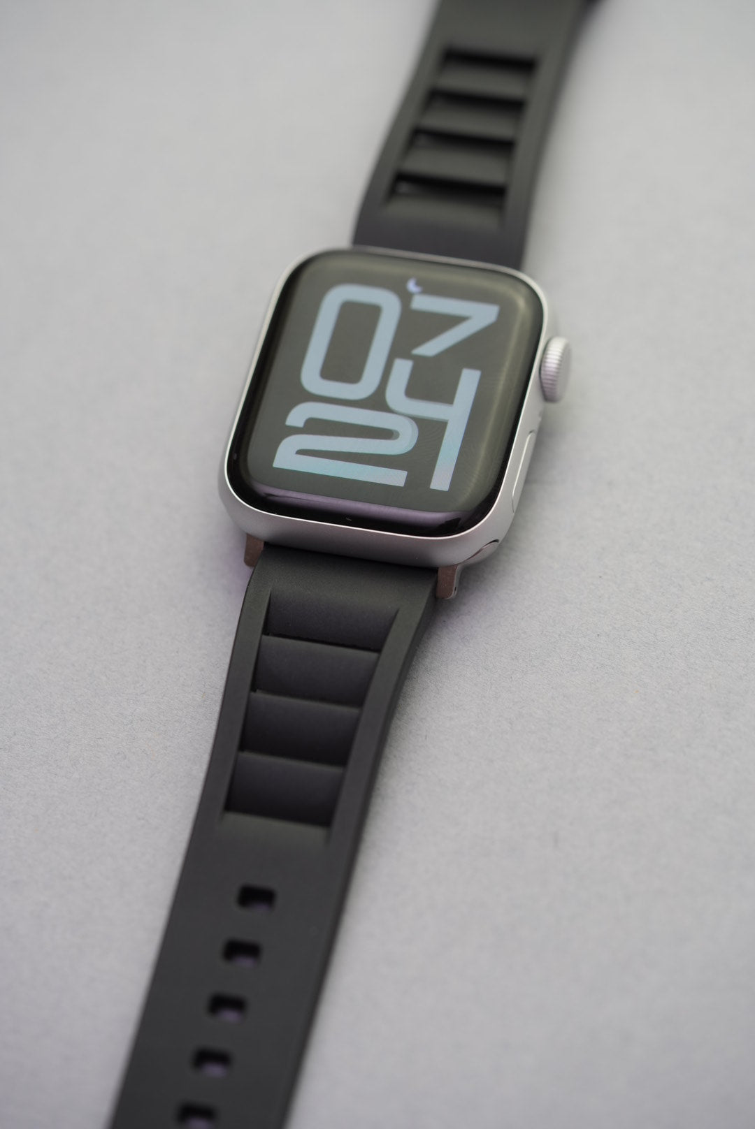 Apple Watch with black FKM vented rubber strap shown from a side angle, illustrating comfort and fit on wrist.