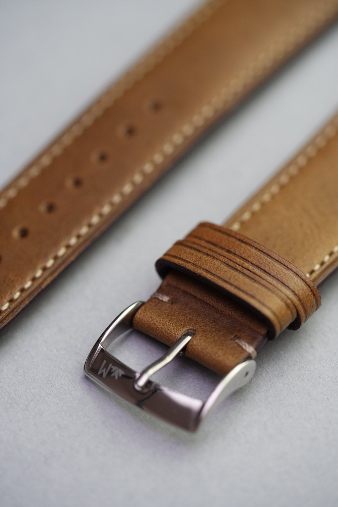 Fine grain calf leather strap in green with high polish stainless steel buckle and contrast stitching
