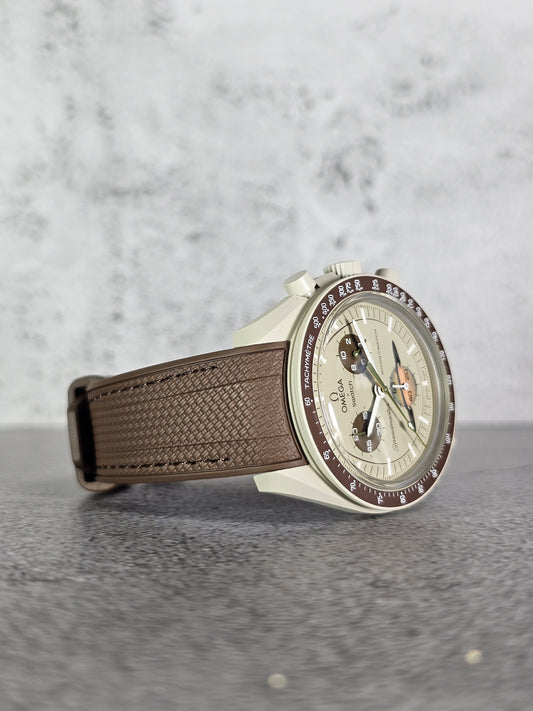 A brown rubber woven strap with a curved edge, designed for a watch with a 20mm lug width, displayed on a grey background.