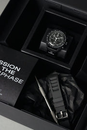Omega x Swatch MoonSwatch Mission to the Moonphase with black rubber strap on display