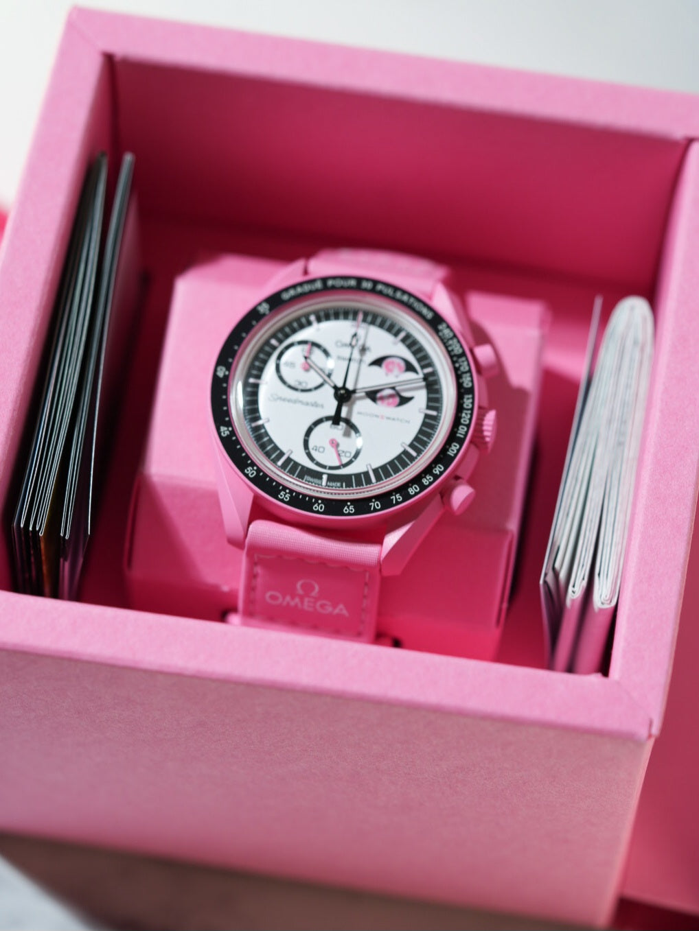 Inside the Swatch x Omega Mission to the Pink Moonphase box – showing the watch neatly packed with manuals and official pink Omega strap.