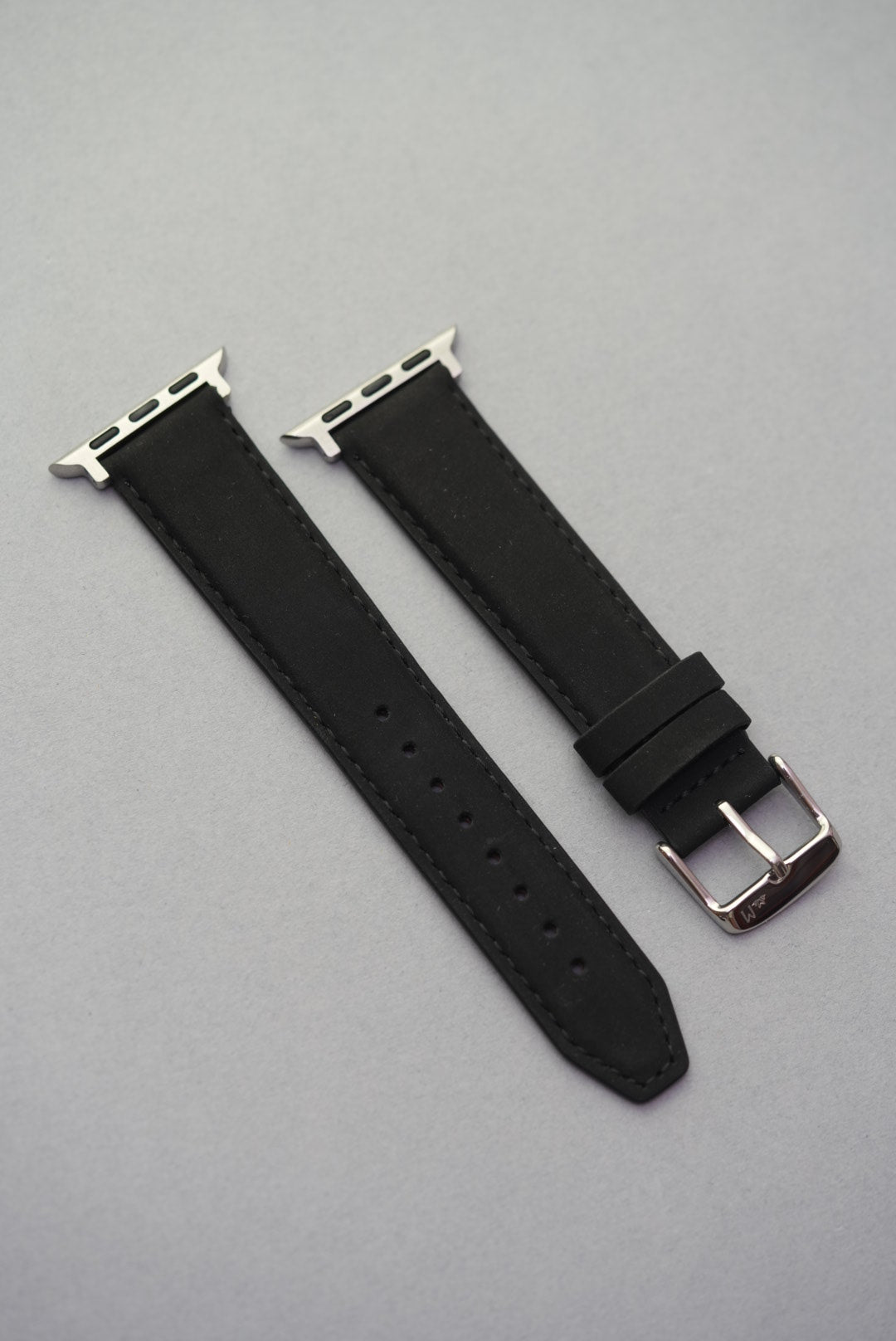 Black nubuck strap fitted to an Apple Watch, shown in full for a clean and modern look.