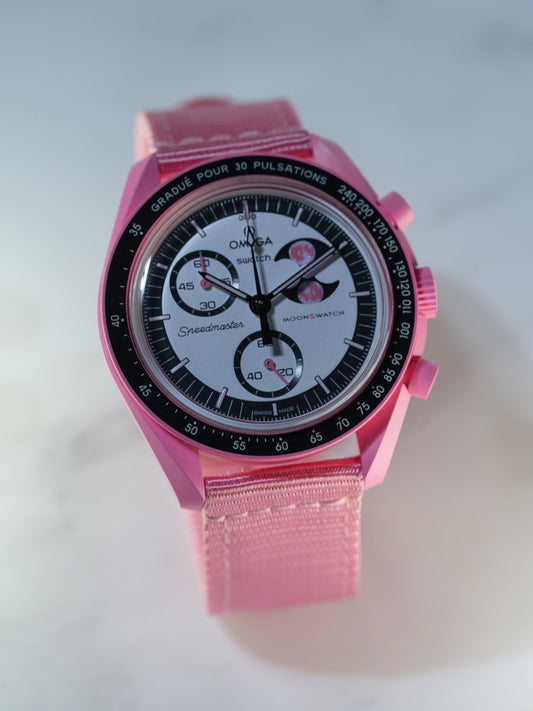 view of the pink nylon strap on wrist – durable double-stitched weave ideal for daily wear on the MoonSwatch Pink Moonphase.