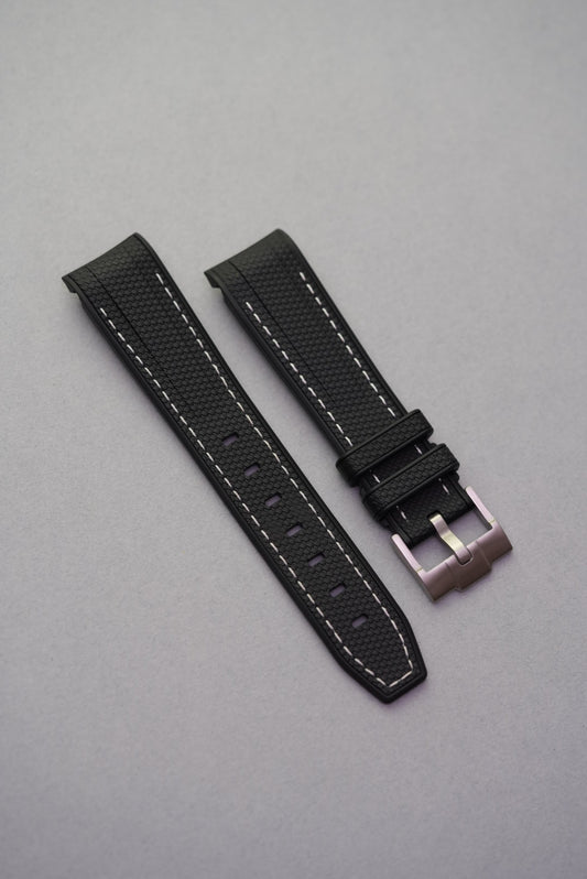 Black woven rubber strap with contrasting white stitching for the MoonSwatch Mission to the Moon, styled for sport and everyday wear.
