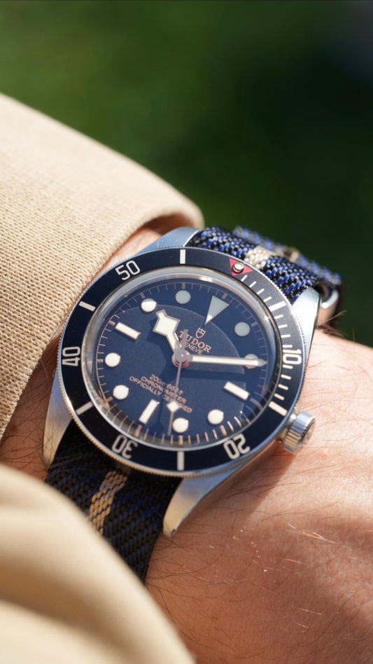 Tudor Black Bay on navy and sand woven nylon strap, wrist shot in sunlight
