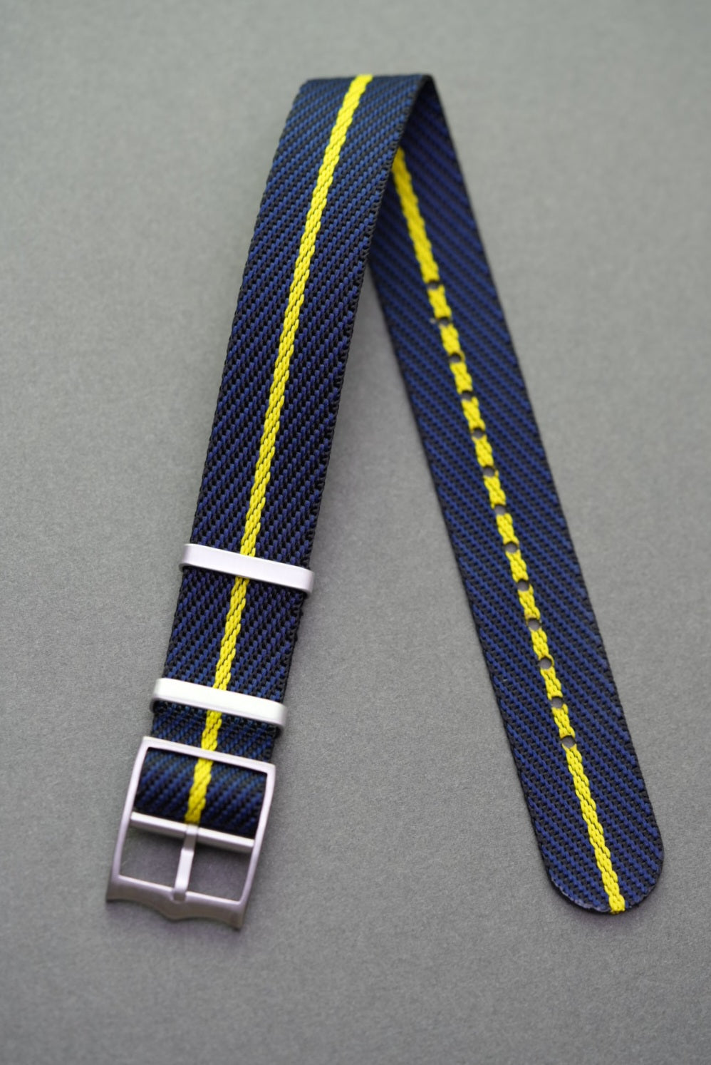 Woven nylon single-pass strap in navy with a vivid yellow centre line, made to suit Tudor models.