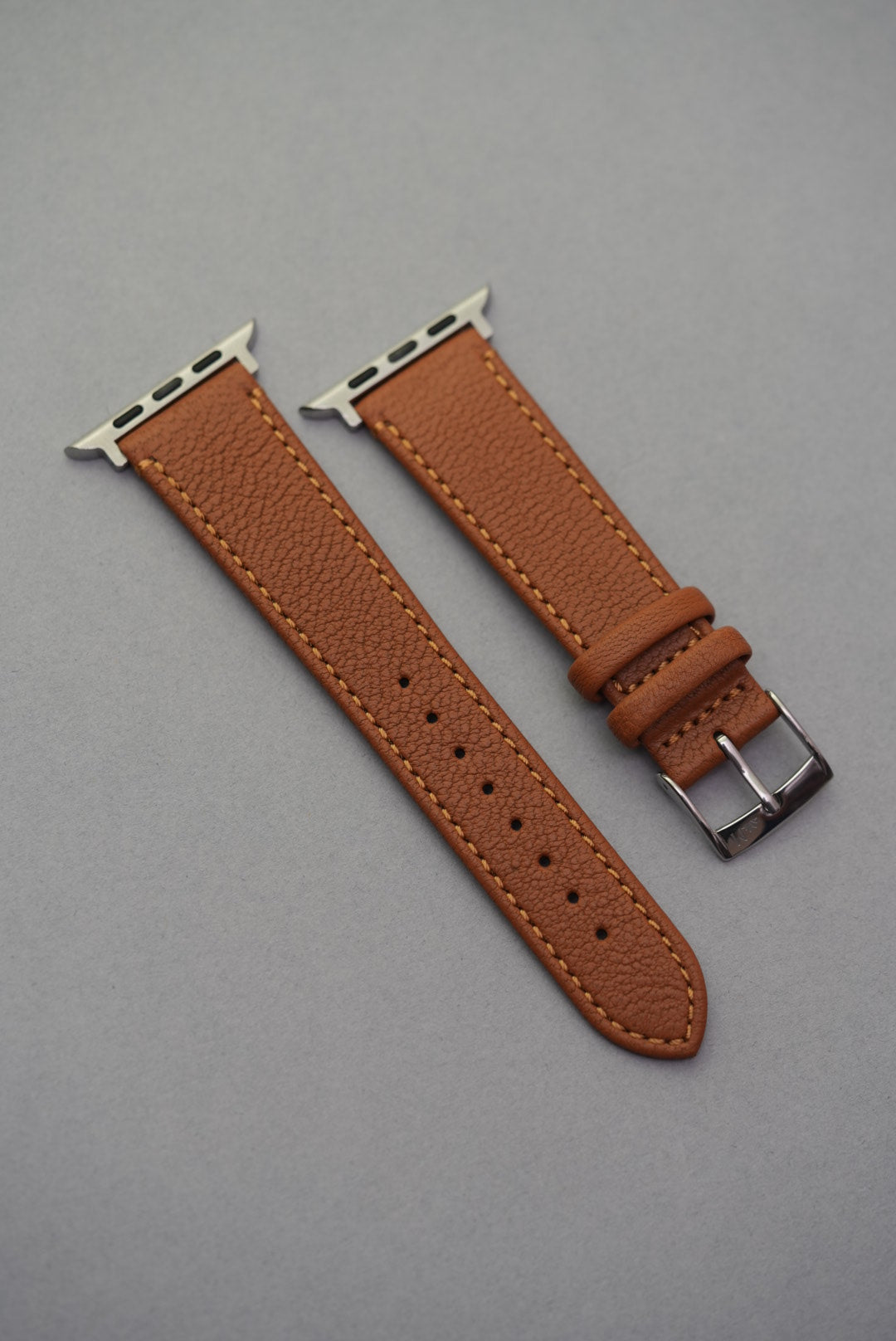 Angled close-up of Apple Watch fitted with Tuscan Sand sheepskin strap, highlighting grain texture and soft structure.