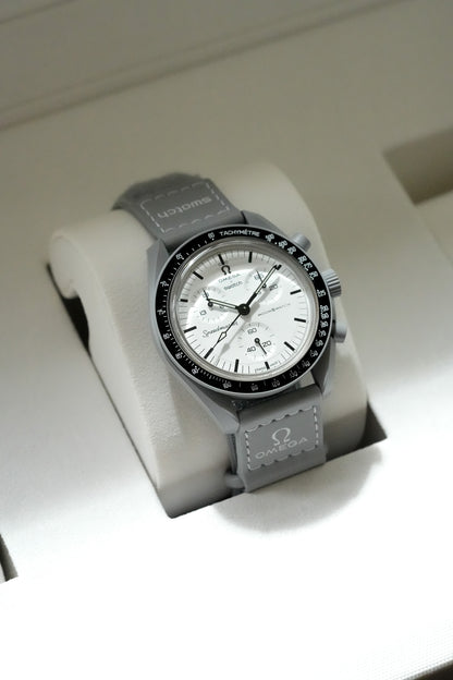 Luxury watch with gray strap on a white stand