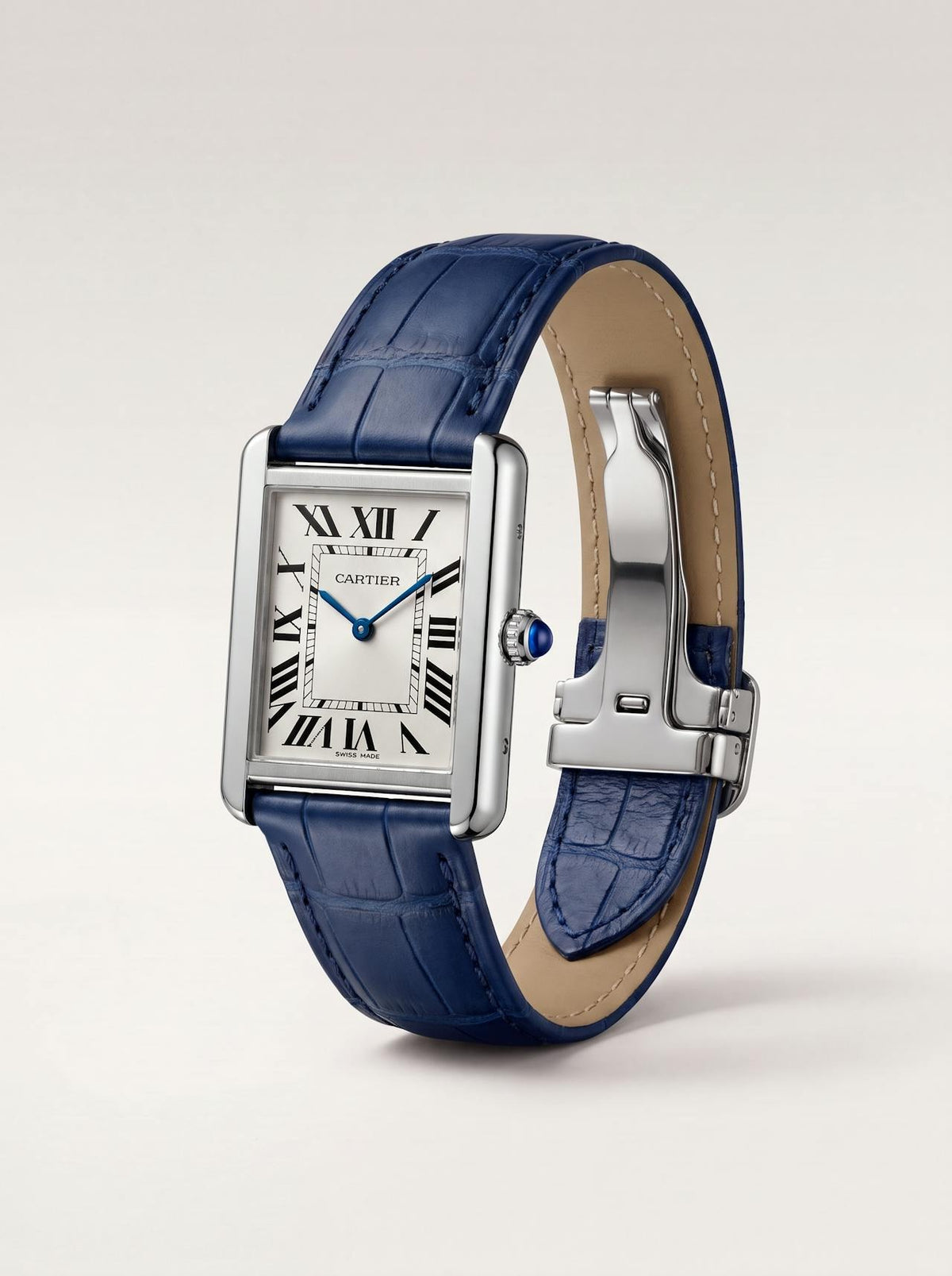Blue square alligator-grain leather Cartier Tank strap, 17.5mm, angled view showing beige lining and folding deployant clasp