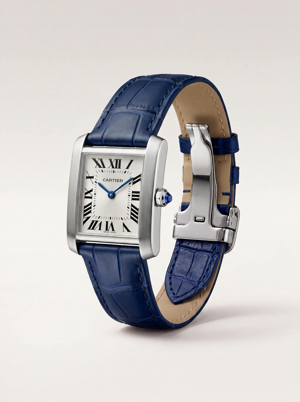 Blue square alligator-grain leather Cartier Tank strap, 18mm, angled view showing beige lining and folding deployant clasp