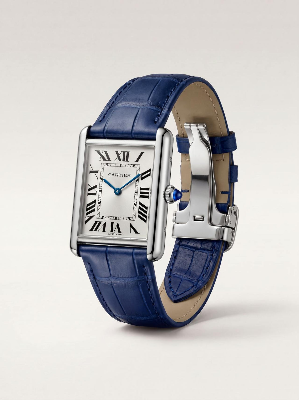 Blue square alligator-grain leather Cartier Tank strap, 23mm, angled view showing beige lining and folding deployant clasp