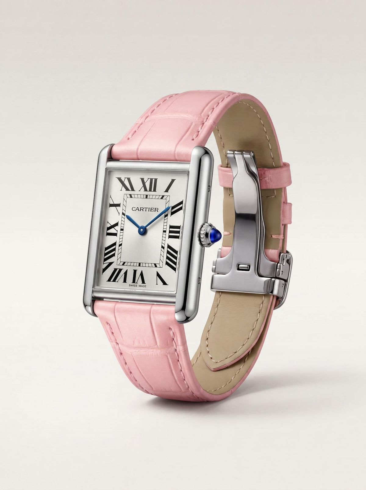 Pink square alligator-grain leather Cartier Tank strap, 23mm, angled view showing beige lining and folding deployant clasp