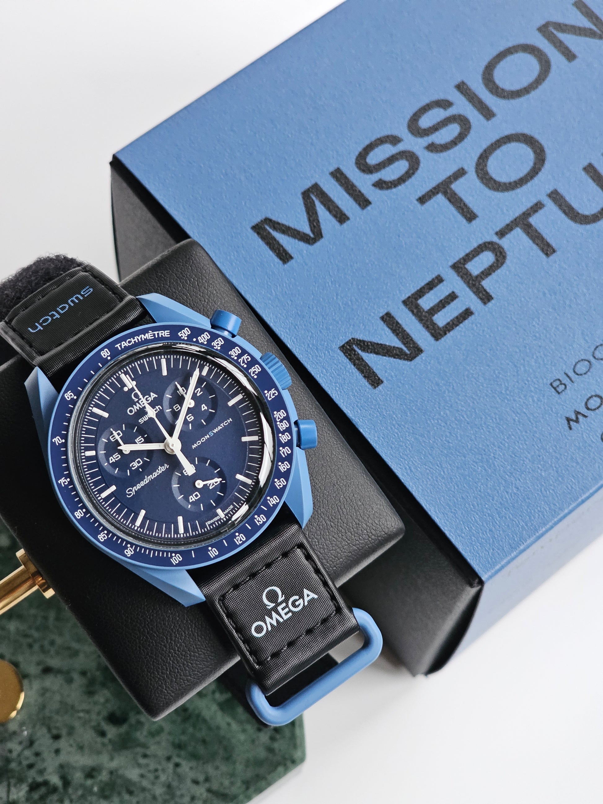 Swatch x Omega Mission to Neptune Swatch Watch and picture of box with text Mission to Neptune Blue Colour swatch x Omega Mission to Neptune Swatch Watch. Model number SO33N100