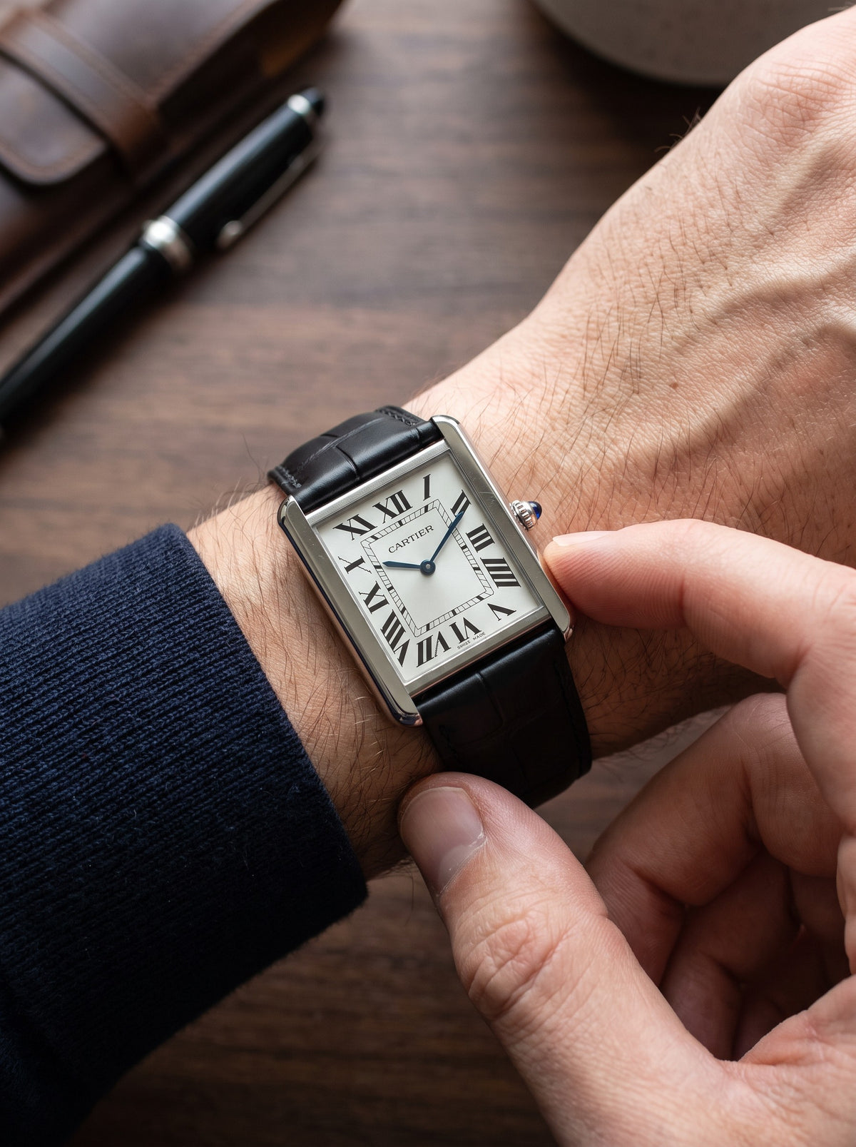 Cartier Tank Solo Large on a black square alligator-grain leather strap, worn on the wrist