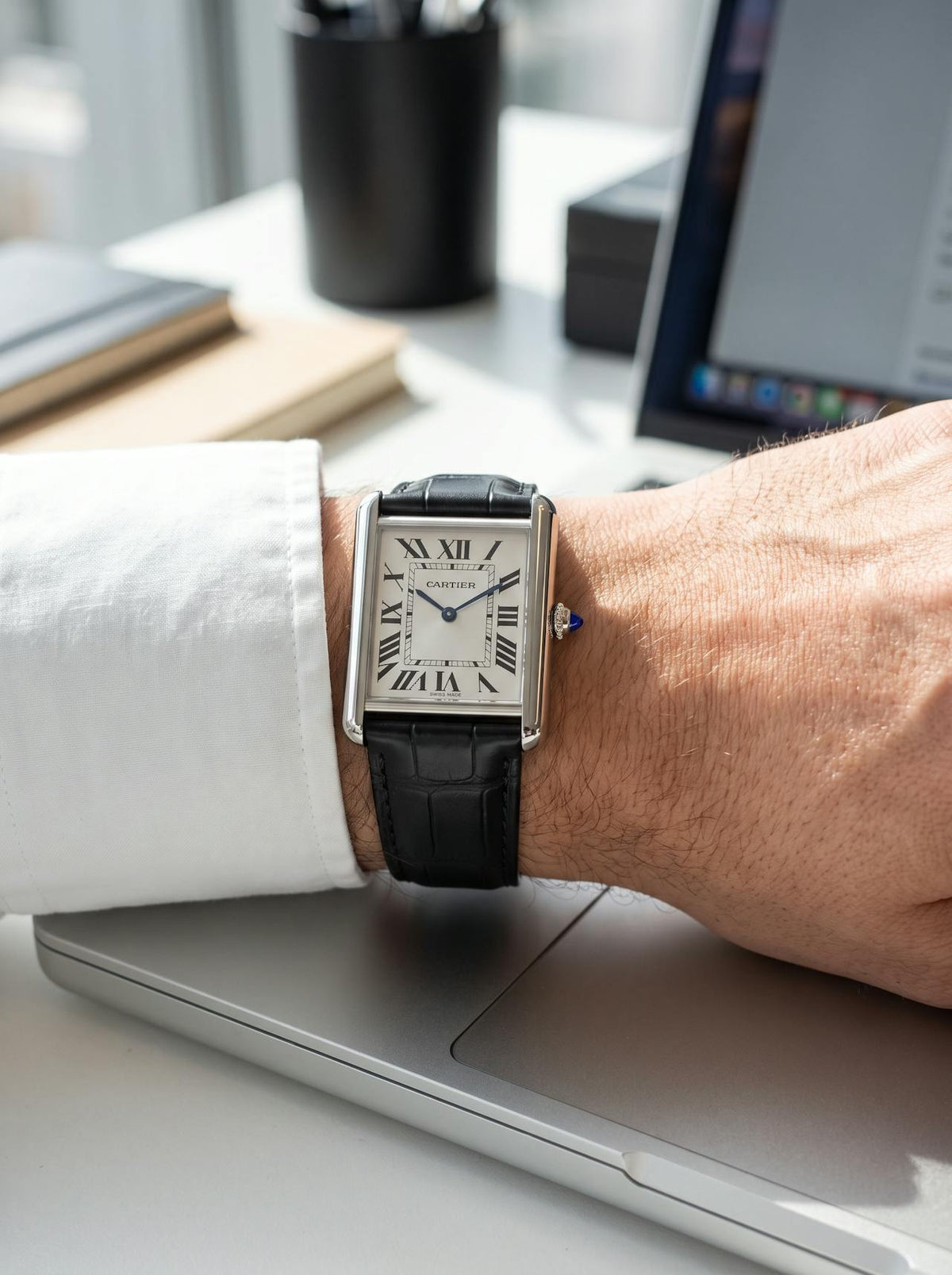 Cartier Tank Must Extra-Large on a black square alligator-grain leather strap, worn on the wrist
