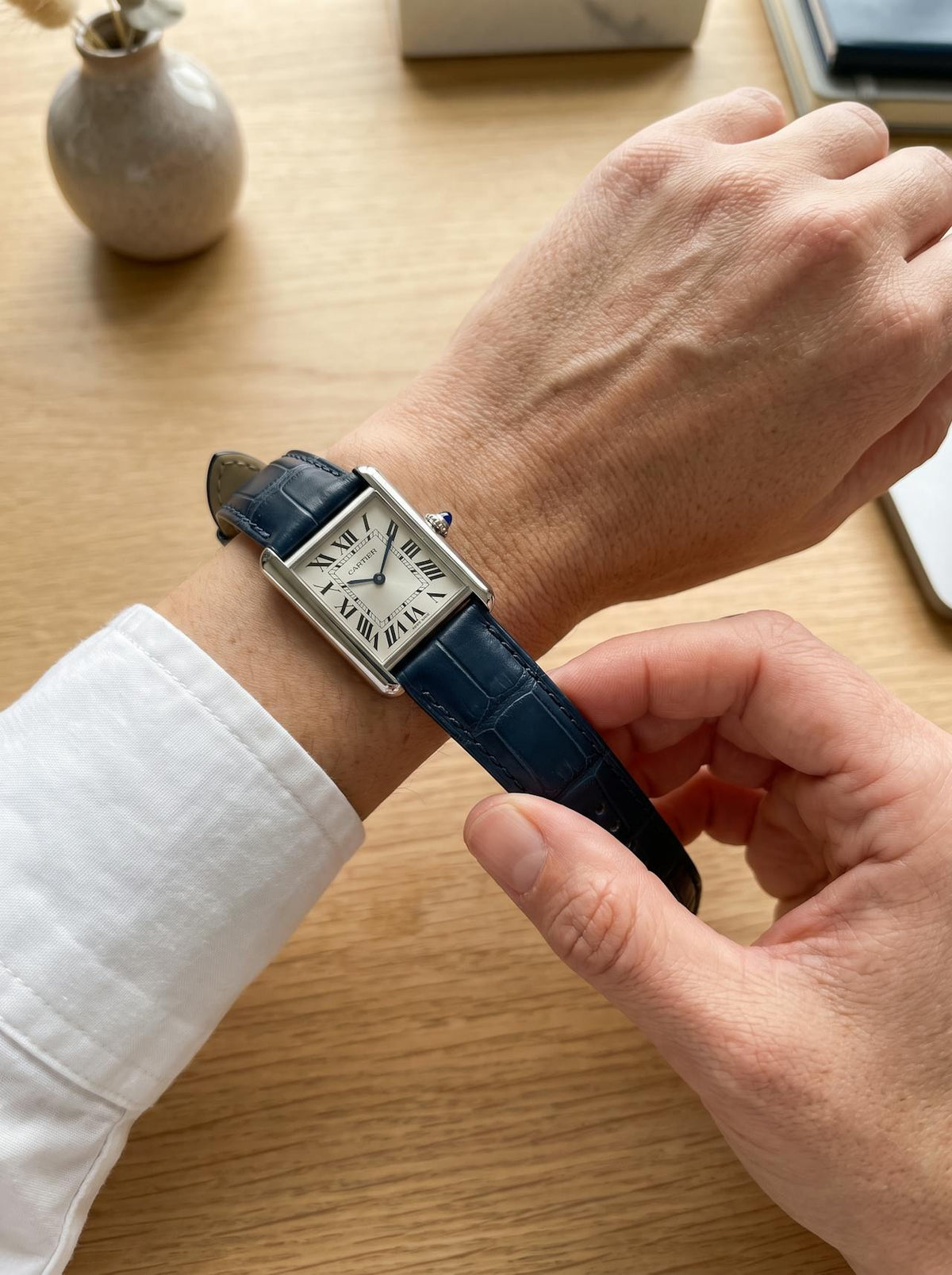 Cartier Tank Must Small on a blue square alligator-grain leather strap, worn on the wrist