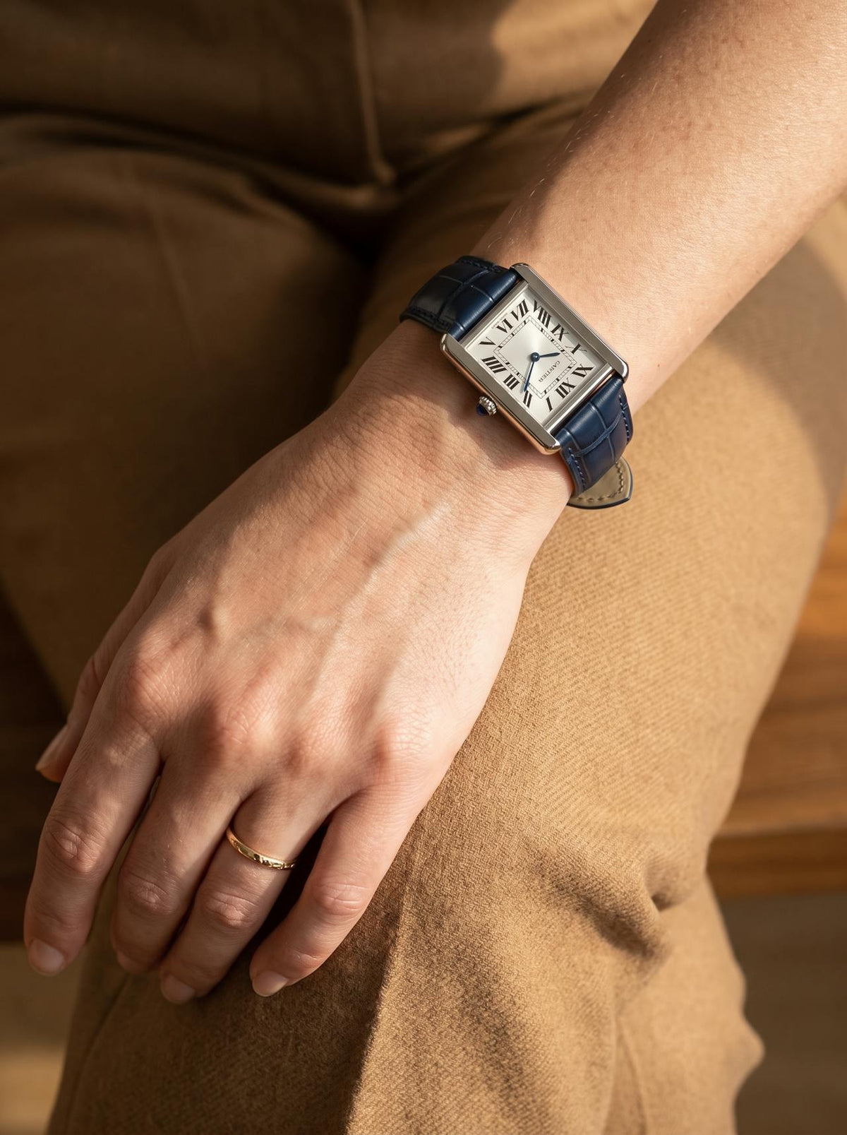 Cartier Tank Solo Small on a blue square alligator-grain leather strap, worn on the wrist