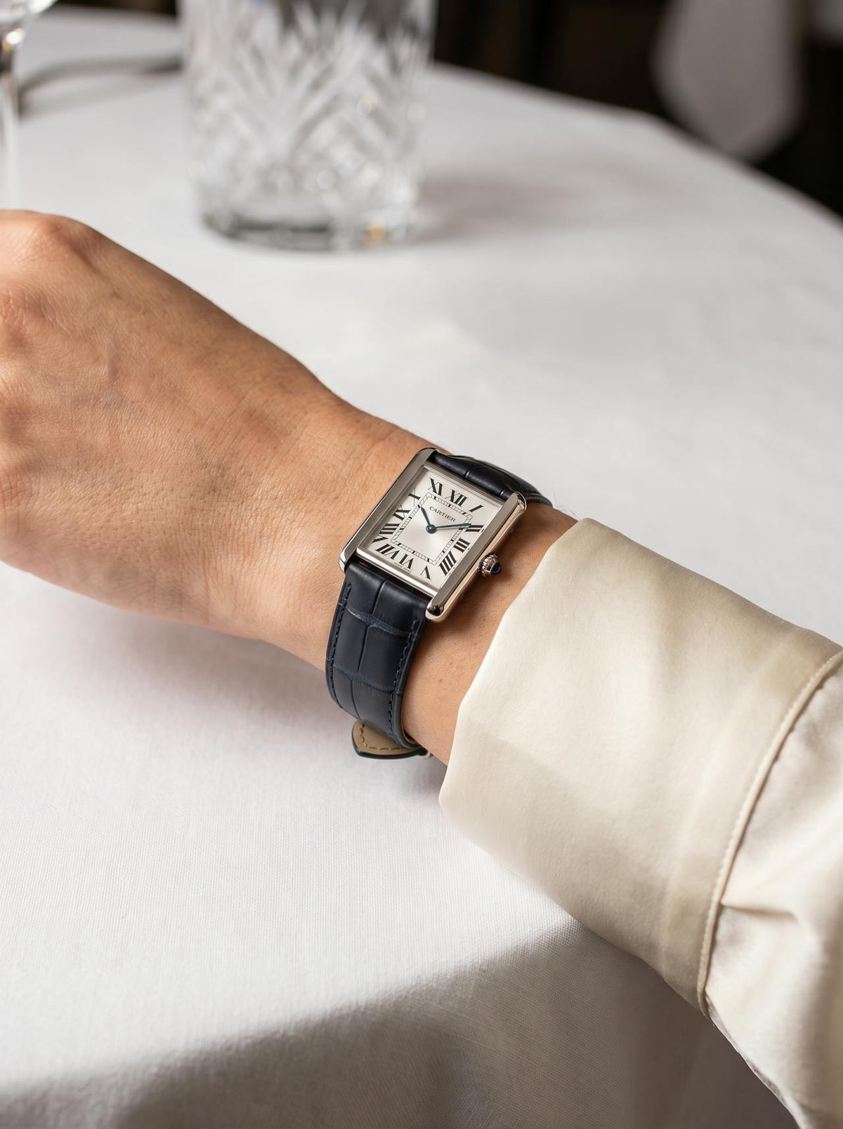 Cartier Tank Française on a blue square alligator-grain leather strap, worn on the wrist