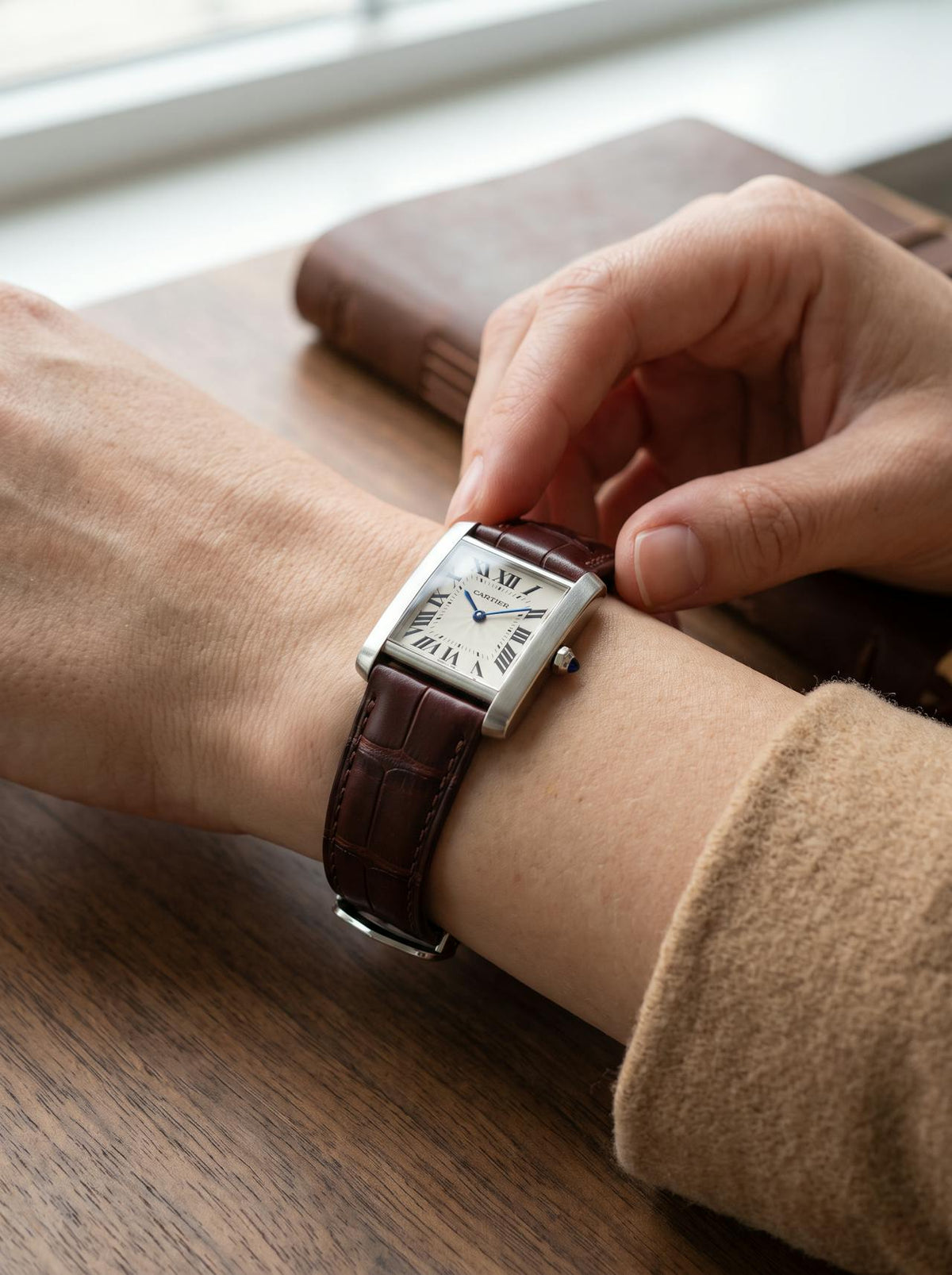 Cartier Tank Française on a brown square alligator-grain leather strap, worn on the wrist