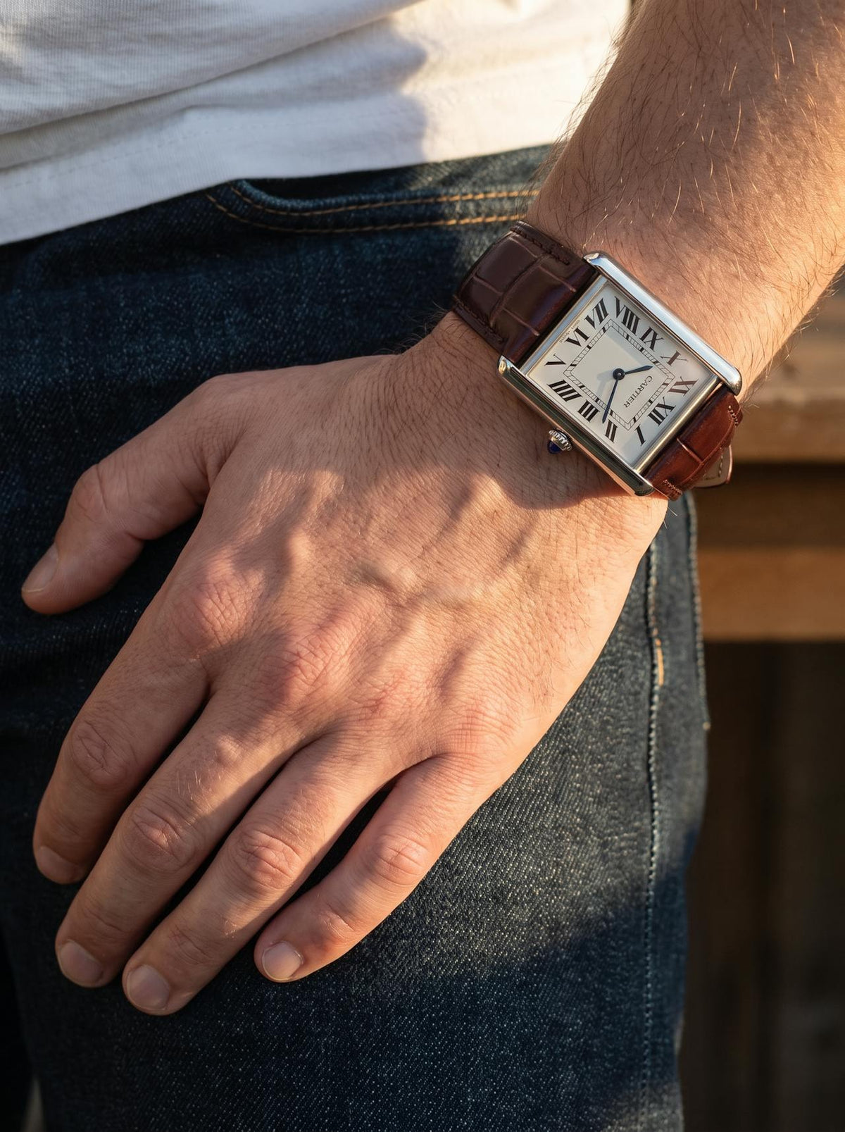 Cartier Tank Must Extra-Large on a brown square alligator-grain leather strap, worn on the wrist