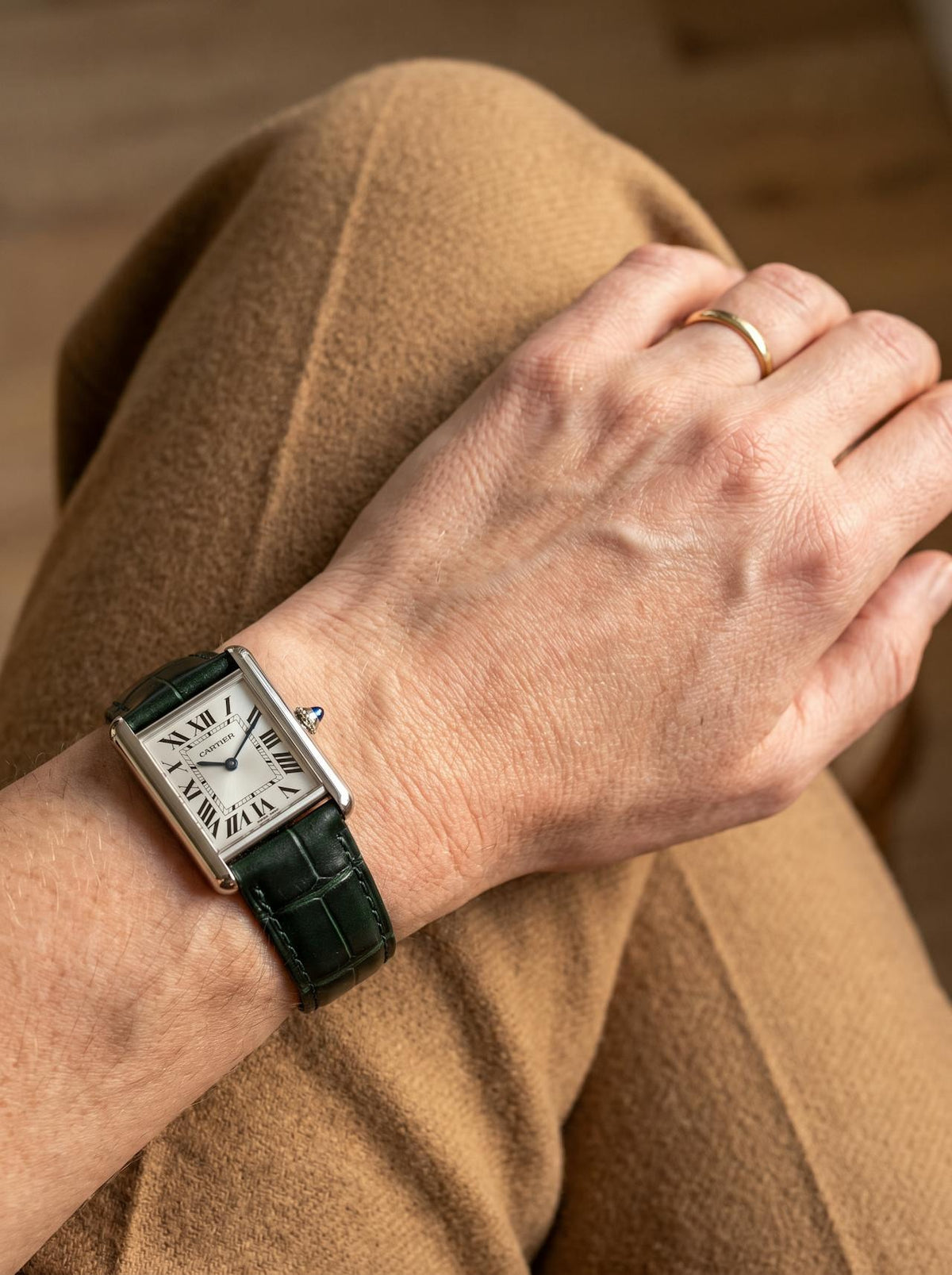 Cartier Tank Must Small on a green square alligator-grain leather strap, worn on the wrist