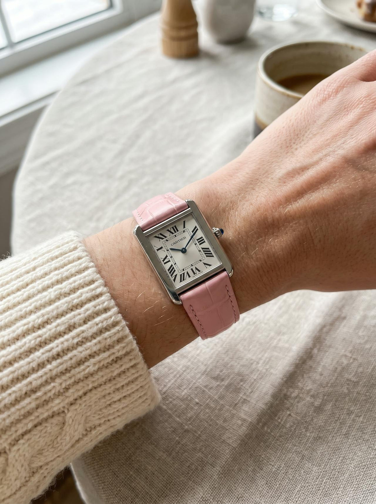 Cartier Tank Solo Small on a pink square alligator-grain leather strap, worn on the wrist