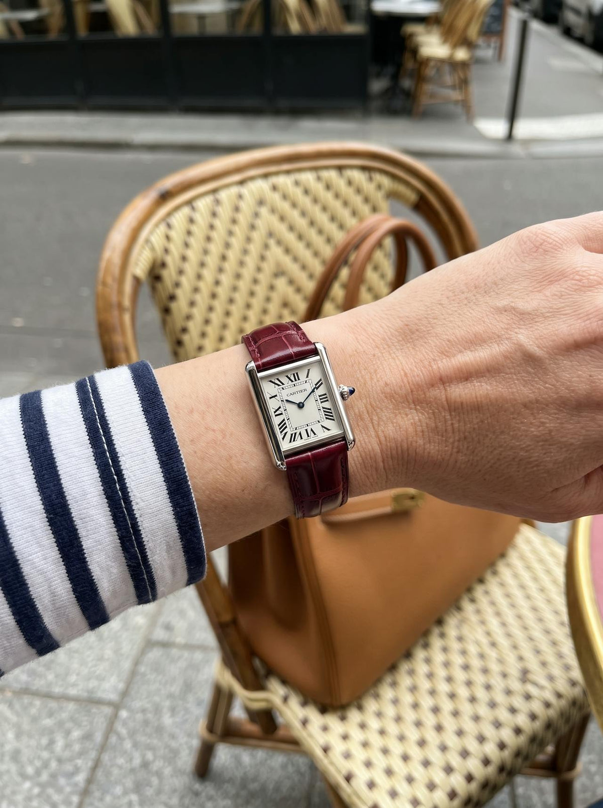 Cartier Tank Must Small on a red square alligator-grain leather strap, worn on the wrist