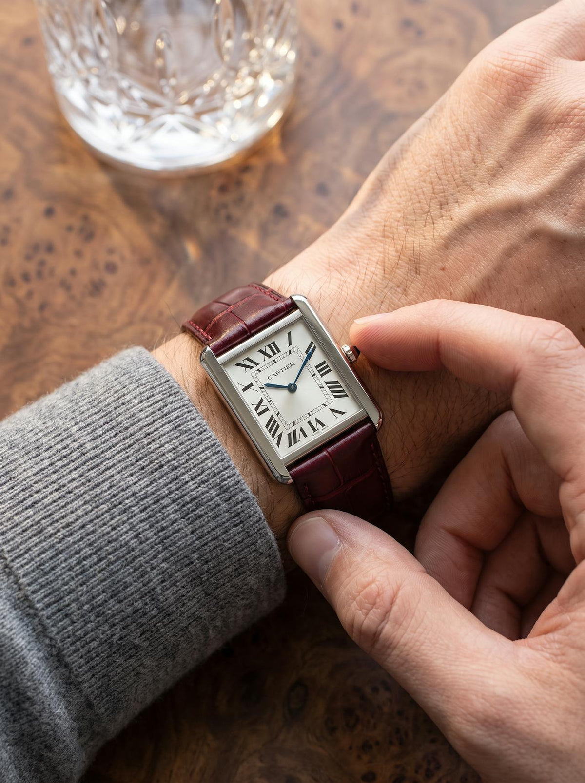 Cartier Tank Française on a red square alligator-grain leather strap, worn on the wrist