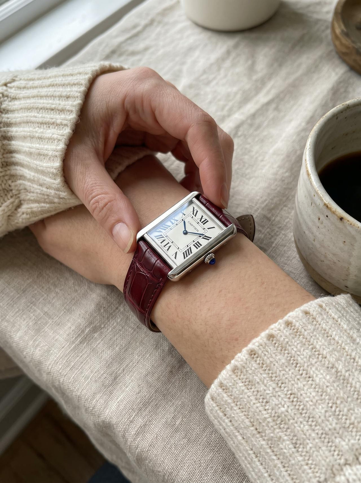 Cartier Tank Solo Large on a red square alligator-grain leather strap, worn on the wrist