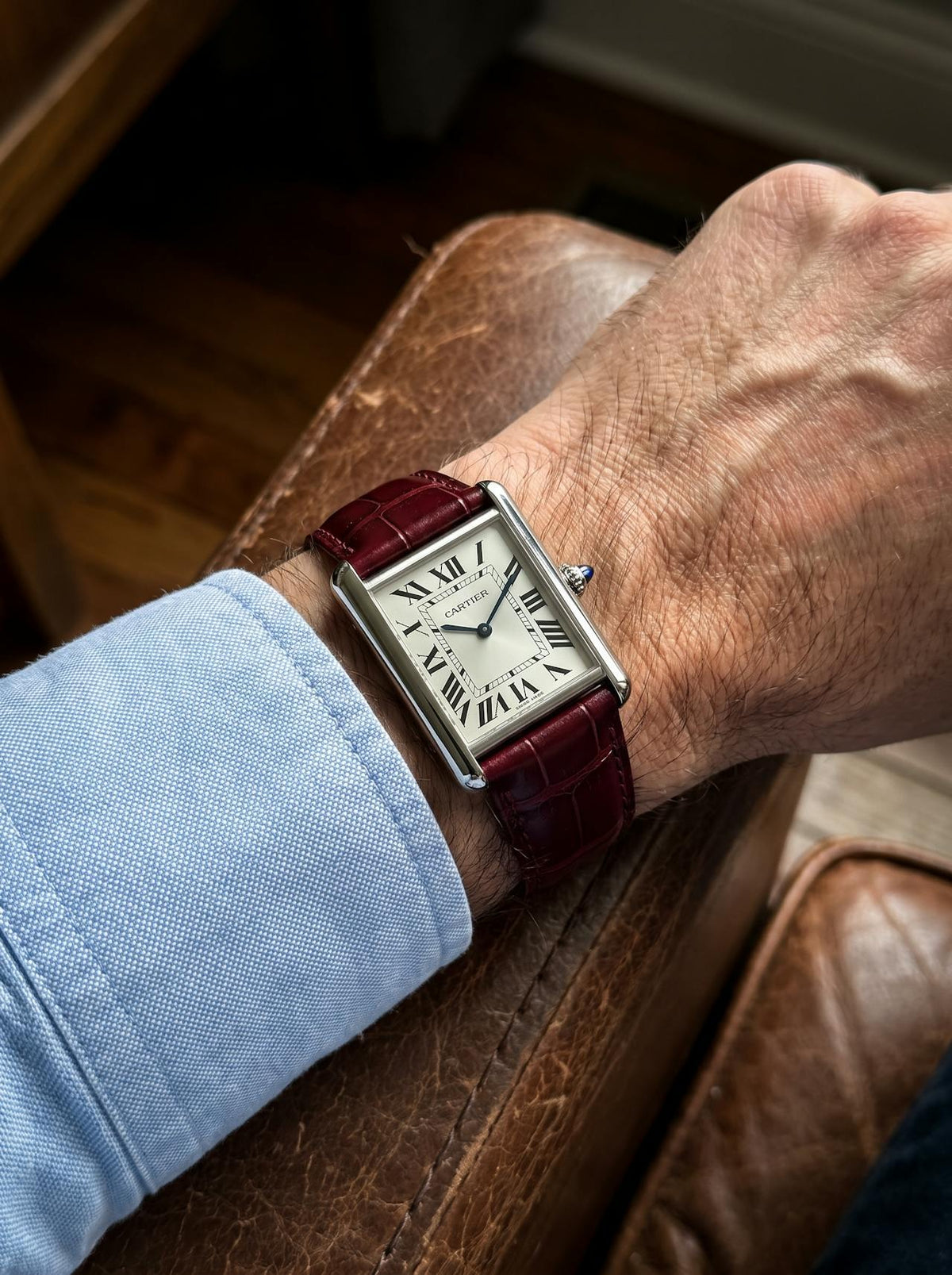 Cartier Tank Must Extra-Large on a red square alligator-grain leather strap, worn on the wrist
