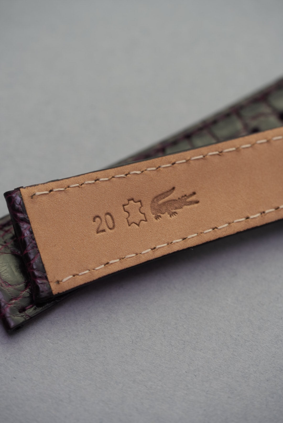 Underside of Bordeaux crocodile strap for Cartier with 20mm lug width and embossed hide stamp, handmade in Italy.