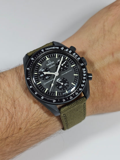 A khaki canvas watch strap with a stainless steel buckle, designed to fit a watch with a 20mm lug width.