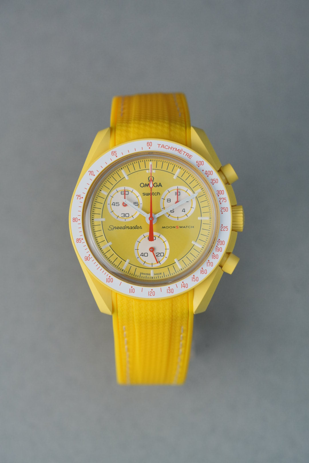 Bright yellow curved-end rubber woven strap with white contrast stitching, tailored for Omega x Swatch MoonSwatch models.