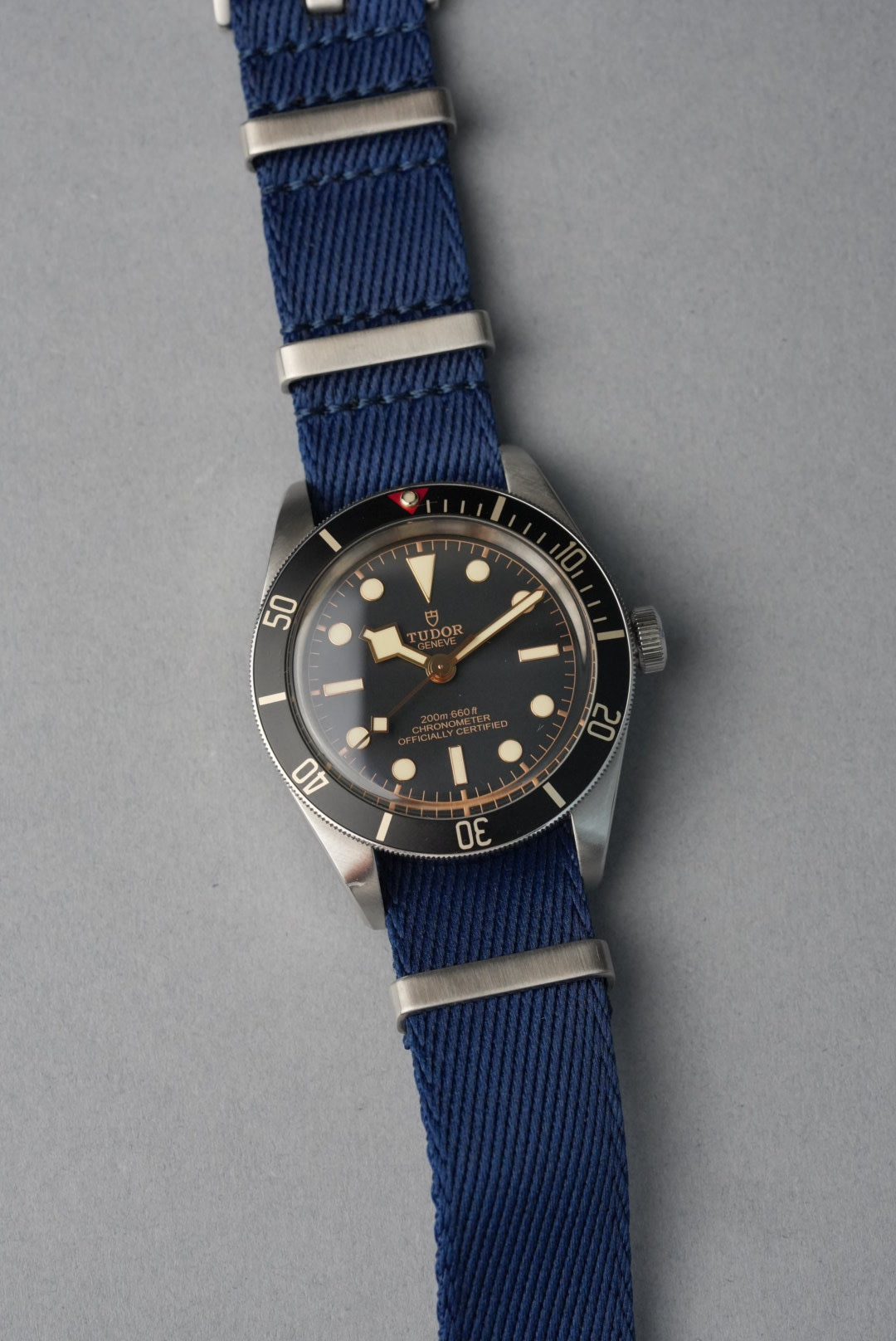 Watch with a blue strap on a gray background